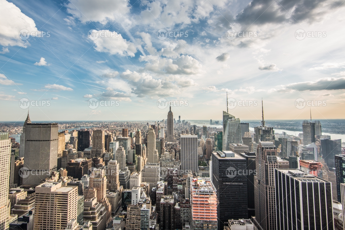 Empire State Building and Manhattan cityscape on bright sunny day ...