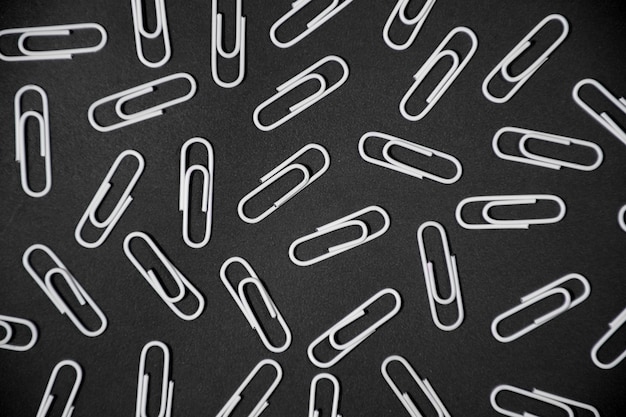 Premium Photo | Paper clips backgorund white paperclips on black ...