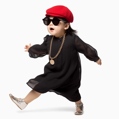 Singer Yoko Ono as a 2 year old toddler, wearing a classic black satin chanel dress, red shoes, red velvet bowler hat, gold silk scarf, dancing, irradiant facial expression, plain white background, clipart