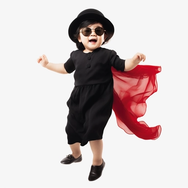Singer Yoko Ono as a 2 year old toddler, wearing a classic black satin chanel dress, red shoes, red velvet bowler hat, gold silk scarf, dancing, irradiant facial expression, plain white background, clipart