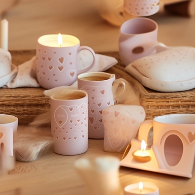 An image filled with loving, homely items that symbolize motherhood, such as a steaming coffee mug, a calming candle, a comfy pillow, and a heart-shaped pendant, all crafted in a paper-cut style. Each item interlinks seamlessly, set against a soft, pastel-toned backdrop, creating an enchanting pattern that encapsulates the warmth and care associated with a mother's love. in Clipart style