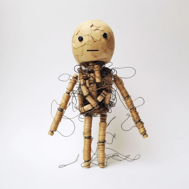 raw minimalist African toy made of corks, capsules, paper clips, wire, rubber bands, tickets, cardboard, cans, sticks, toothpicks, nuts, springs